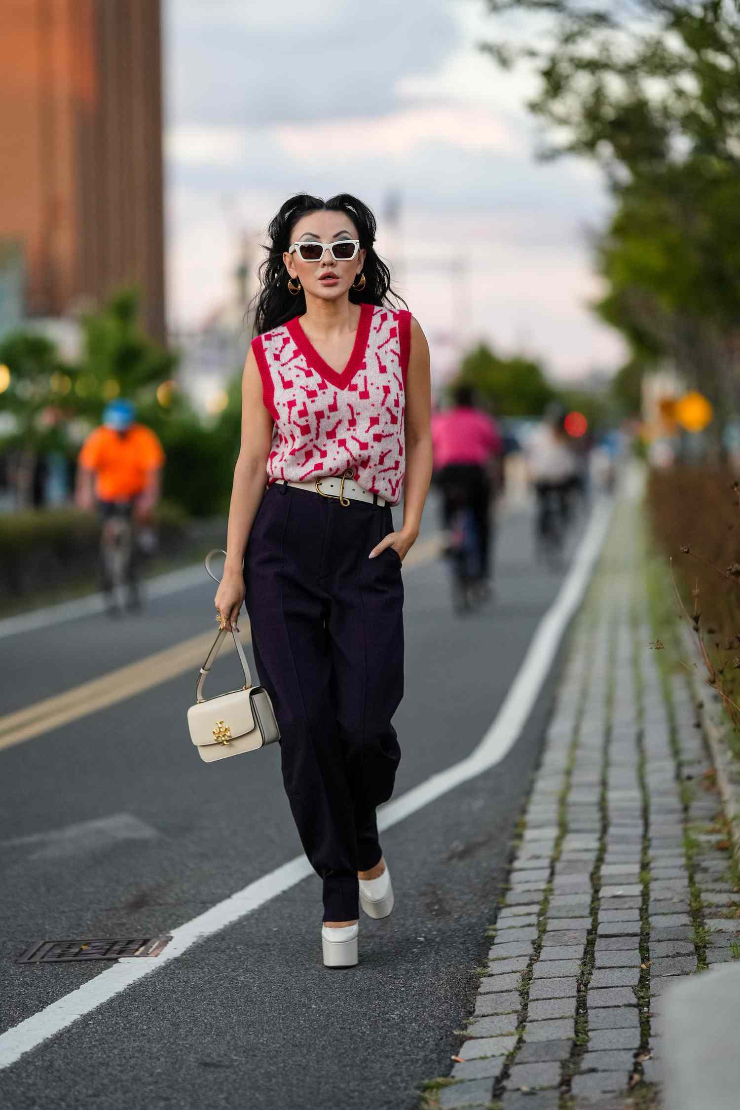 How to style a red and black sweater vest with black shirt? Get this trendy look!