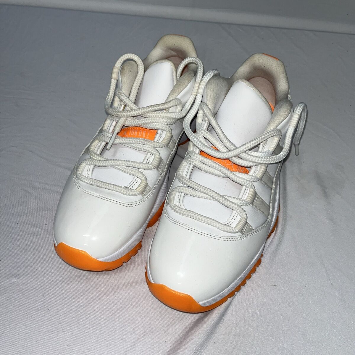 What is the price for white orange 11s? Find the latest cost information.